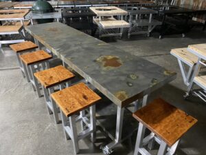 Horizontal view of long worktable with stools