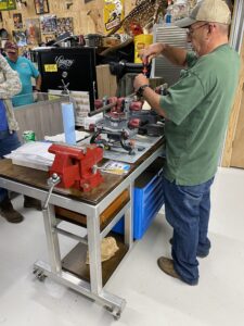 Man is on work at one of the tables in the workshop